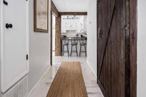 a hallway with a wooden door and a rug at The PanAm fire pit bbq kid & dog friendly in Pensacola