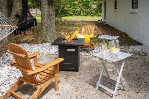 a patio with two chairs and a table and a grill at The PanAm fire pit bbq kid & dog friendly in Pensacola