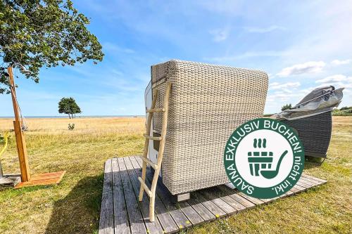 a sign for a new buffalo sign in a field at Tiny House Pioneer 3 - Green Tiny Spot Schillig in Wangerland