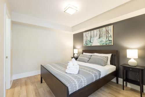 a bedroom with a bed with two pillows on it at Modern 1BR Condo w Patio in Vibrant Front Street in Toronto