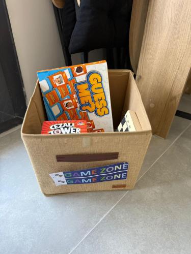 a box of board games sitting on the floor at Erdem Apart77 in Dalaman