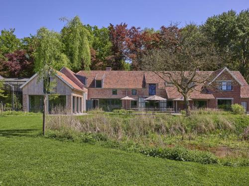 a large house with a yard in front of it at Villa Lactea in Schilde