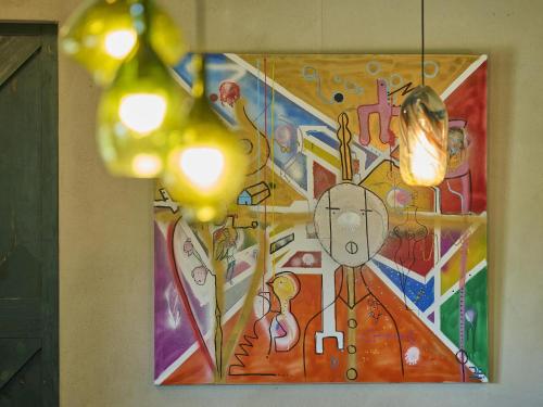 a painting on a wall with lights on it at Villa Lactea in Schilde
