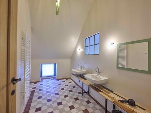 a bathroom with two sinks and a mirror at Villa Lactea in Schilde