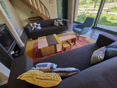 a living room with a couch and a table at Villa Lactea in Schilde