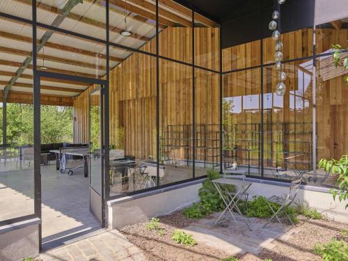 a building with wooden walls and glass windows at Villa Lactea in Schilde
