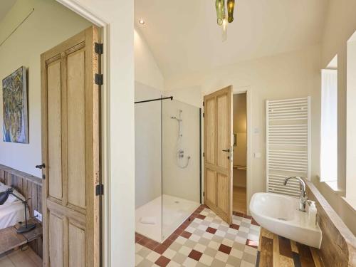 a bathroom with a tub and a sink and a shower at Villa Lactea in Schilde