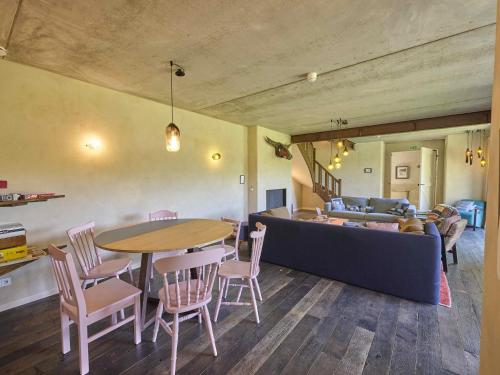 a living room with a table and a couch at Villa Lactea in Schilde