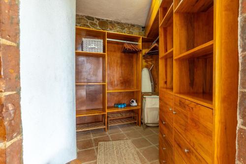 a room with wooden shelves in a room at CasaPiedra in Puerto Escondido