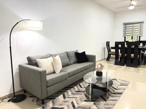 a living room with a couch and a table at Encanto de Playa Sur By GEstores in Mazatlán