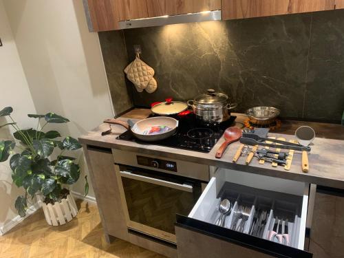 a kitchen with a stove with pots and pans on it at Tirana Magnifique Apartments in Tirane