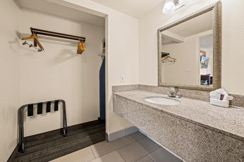 a bathroom with a sink and a mirror at Heritage Inn Express Roseville in Roseville