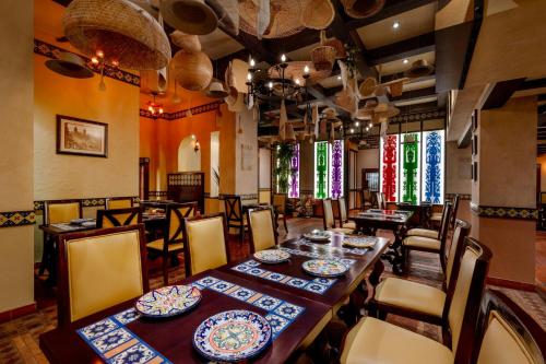 a dining room with a long table and chairs at Gulf Hotel Bahrain Convention and SPA in Manama
