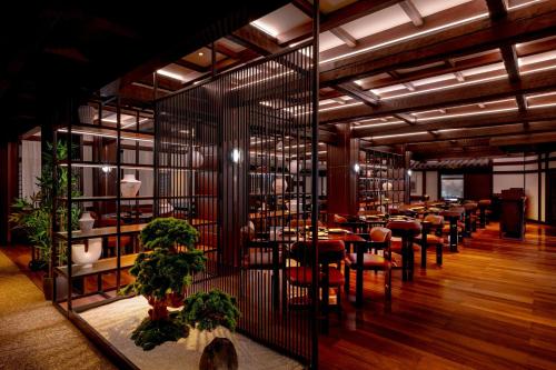 a restaurant with tables and chairs in a room at Gulf Hotel Bahrain Convention and SPA in Manama