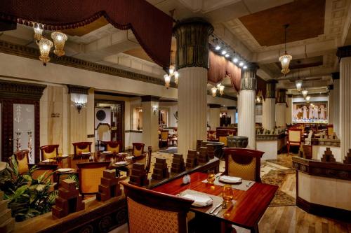 a restaurant with a long table and chairs at Gulf Hotel Bahrain Convention and SPA in Manama