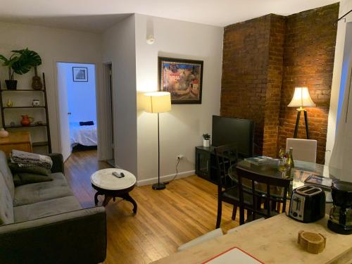 a living room with a couch and a table at PRIME LOCATION 2 BEDROOMS APT UPPER EAST SIDe in New York