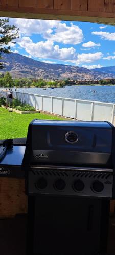 a stove top oven in front of a view of a lake at Richter Pass Beach Resort in Osoyoos