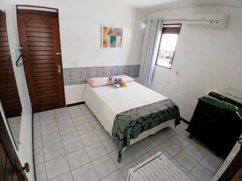 a small bedroom with a bed and a window at Pousada Aconchego do Tambaú in João Pessoa