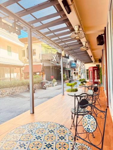 a patio with a table and chairs on a porch at Anchan Hotel & Spa in Hua Hin