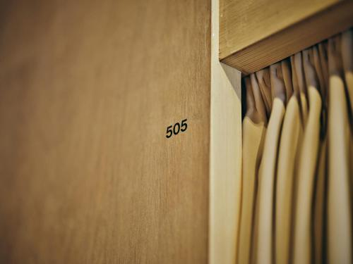 a wooden cabinet with the number on it at Hotel URO in Nagasaki