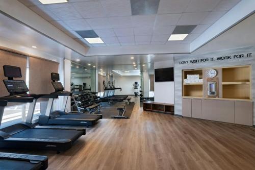 a gym with a row of treadmills and a clock at Fairfield by Marriott Inn & Suites Phoenix West Chandler in Phoenix