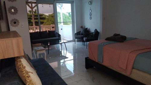 a bedroom with a bed and a living room with a couch at Golden Sun Penthouse VIP in Playa Blanca