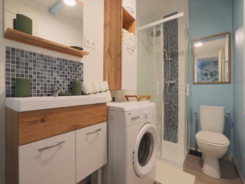 a bathroom with a washing machine and a sink at Holiday Home in Gargas with Pool and Nature in Gargas