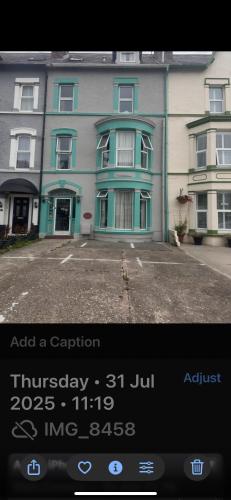 a picture of a building with a sign in front of it at Mayfair House in Llandudno