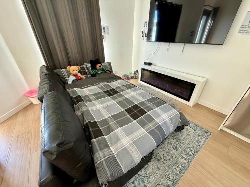 a bedroom with a bed with two teddy bears on it at 5min Walk to Lift 3BR Luxe Chalet with Views & Fire in Mount Buller