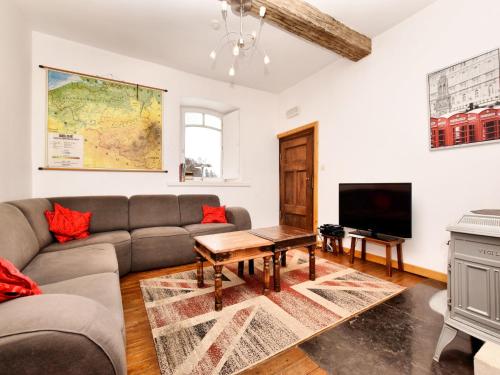 a living room with a couch and a tv at Group Retreat in Robertville in Robertville