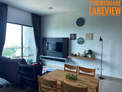 a living room with a table and a television at Cybersquare Lakeview with Netflix and Disney Hotstar in Cyberjaya