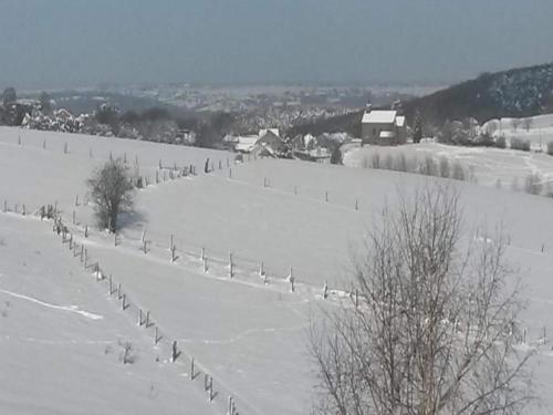 a field covered in snow with a fence at Peaceful Retreat in Ferrières in Ferrières