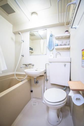 a bathroom with a toilet and a sink at 泉音屋 in Fukuoka