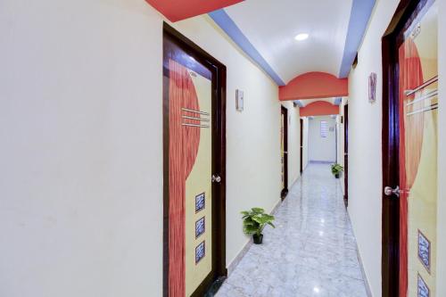 a corridor in a building with a hallway at Hotel O Krishna Palace in Dehu