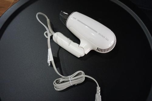 a white hair dryer sitting on a table at クールでおしゃれ 駅徒歩1分 1 min walk from Station 30 minutes to Ghibli Park in Nagoya