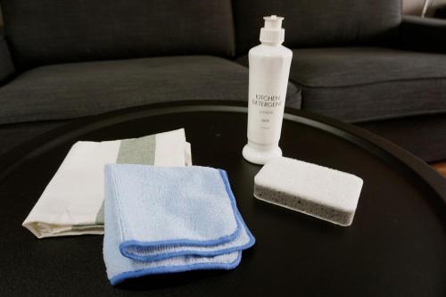 a table with a bottle of soap and towels on it at クールでおしゃれ 駅徒歩1分 1 min walk from Station 30 minutes to Ghibli Park in Nagoya