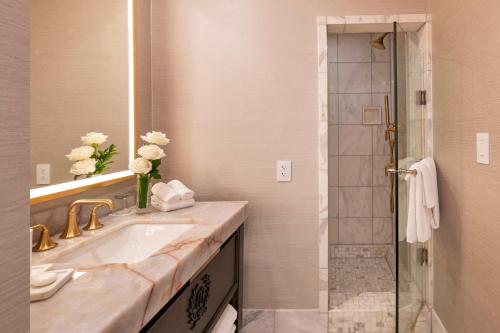 a bathroom with a sink and a shower at Willard InterContinental Washington by IHG in Washington