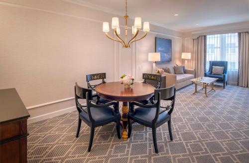 a dining room with a table and chairs and a living room at Willard InterContinental Washington by IHG in Washington