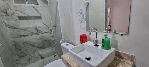 a bathroom with a sink and a shower at Cantinho do ACE in Vila Velha