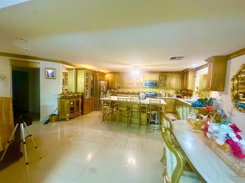 a large kitchen with wooden cabinets and tables and chairs at Shadow Cove Property in Las Vegas