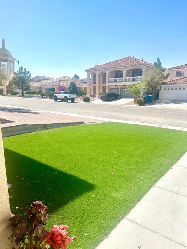 a patch of green grass next to a street at Shadow Cove Property in Las Vegas