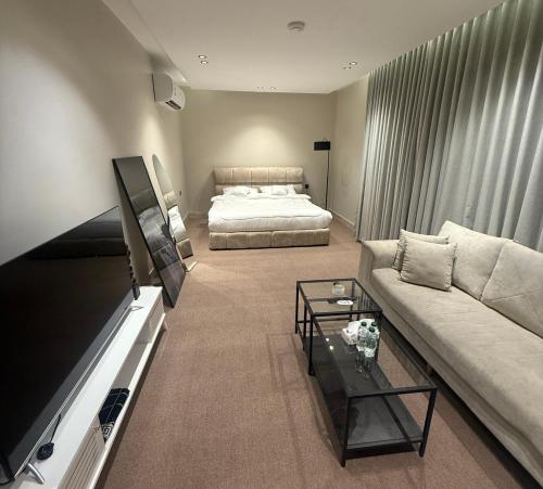 a living room with a couch and a bed at استديو الهدوء in Dammam