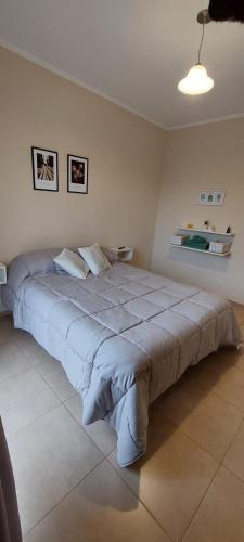 a bedroom with a large bed in a room at Departamento Naon SP in San Pedro