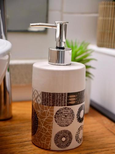 a soap dispenser sitting on top of a bathroom counter at SWEET HOME plage privée in Folle Anse