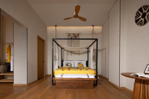 a bedroom with a bed with a yellow comforter at Manli Hotel Shanghai Pudong Airport Branch -Provide free shuttle buses to Pudong Airport and Disneyland in Shanghai