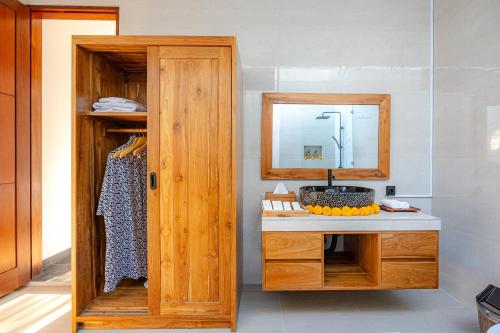 a bathroom with a sink and a mirror at Cabaña de piña dulce ubud in Ubud