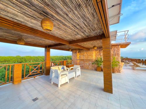 a patio with chairs and tables on a balcony at Suite Brisa Mulata en Laguna Beach, Tolú in Tolú