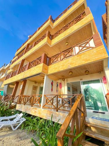 a house on the beach with a deck at Suite Brisa Mulata en Laguna Beach, Tolú in Tolú