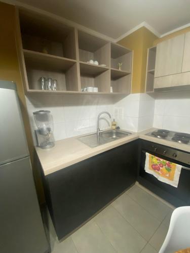 a small kitchen with a sink and a stove at Casa Laguna in Concepción