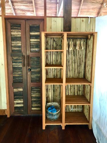 a book shelf in a room with a door at Casa Prana, Termales, Nuqui in Nuquí